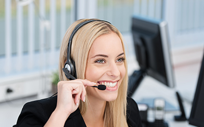 Dental personnel (front office staff) with a headset smiling